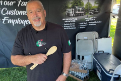 Sales-Rep-at-booth-handing-out-prizes